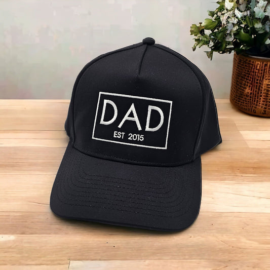 black baseball cap with DAD EST embroidered
