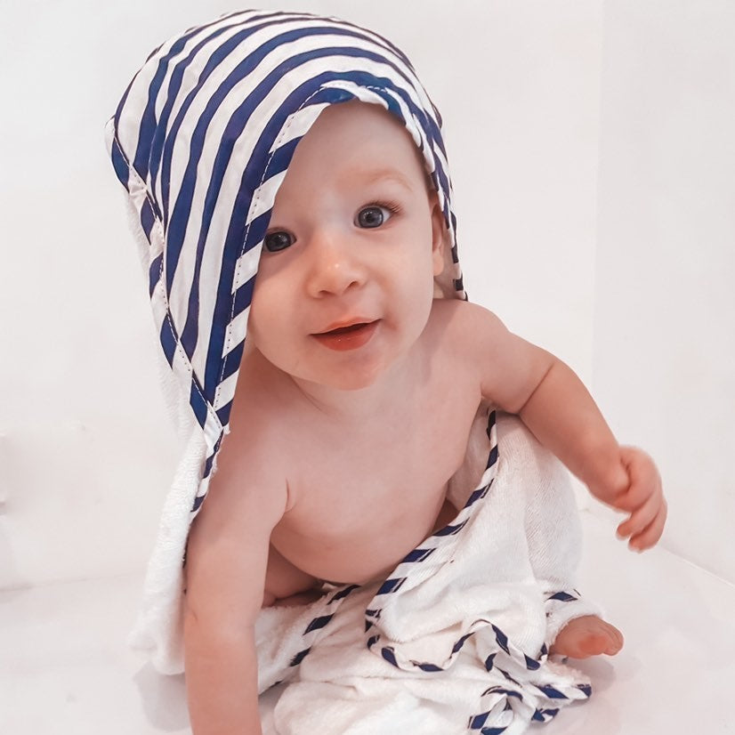 child wearing navy blue stripe hooded bath towel newborn gift personalise with baby name embroidery