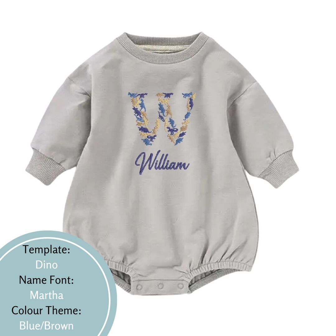 grey bubble romper embroidered in a dino name design with a blue and brown colour theme