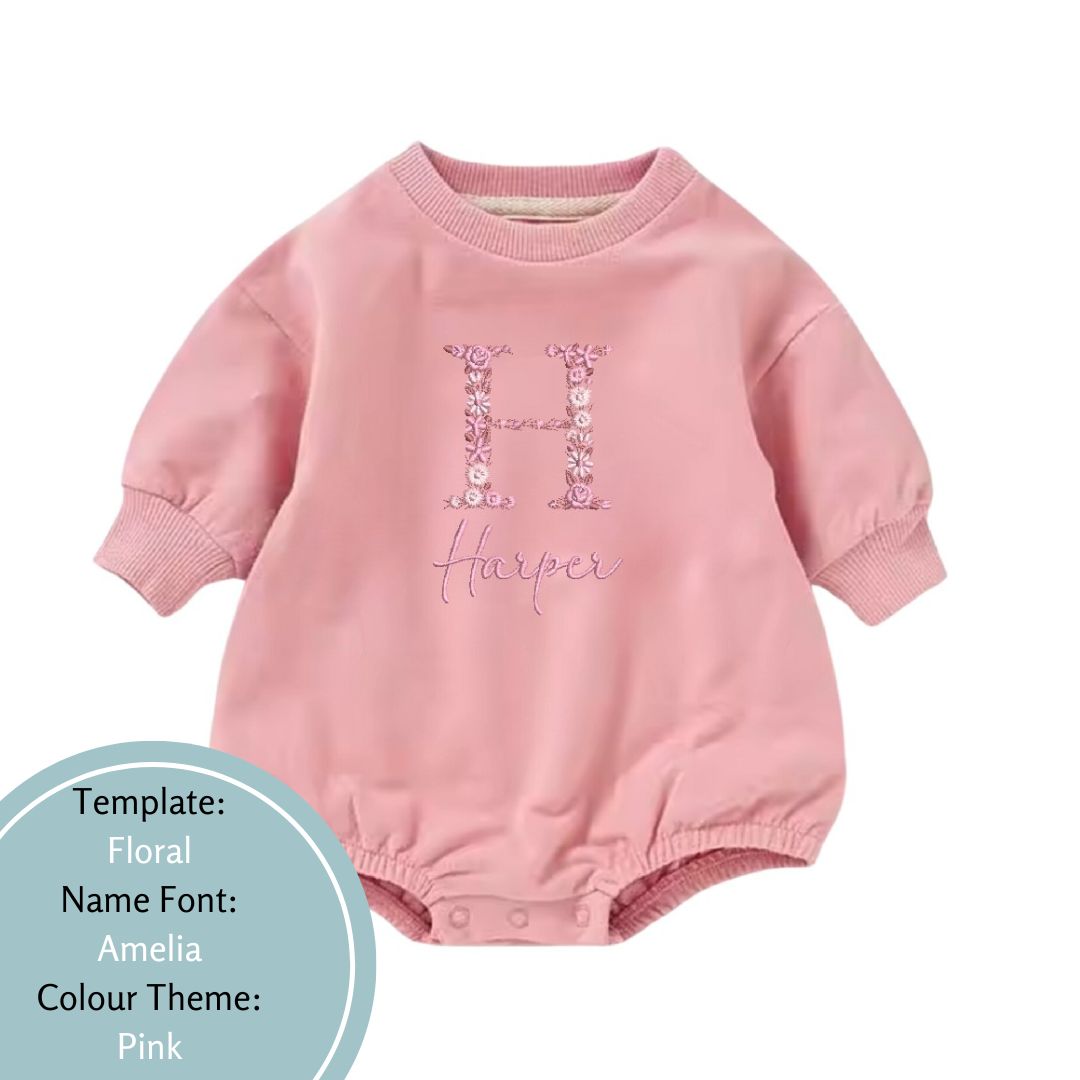 pink baby bubble romper embroidered in a floral name design using a pink colour theme