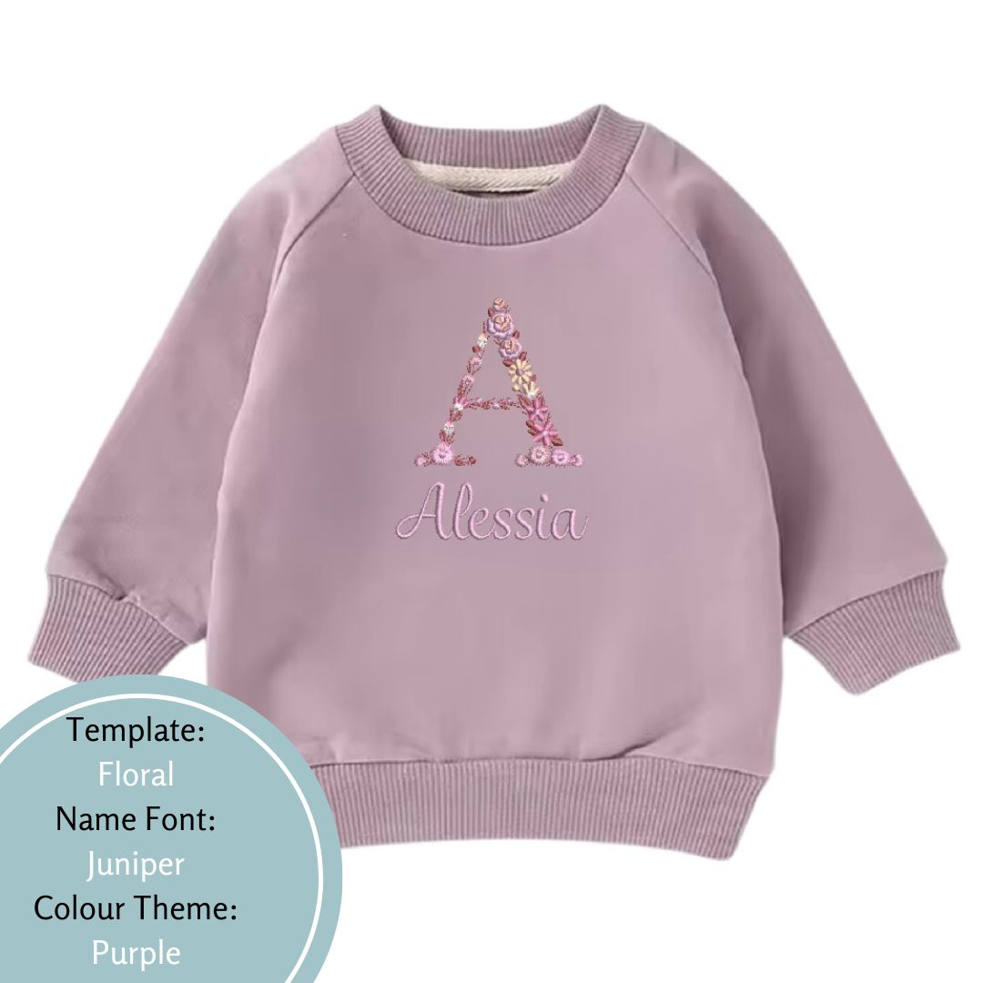 purple baby and toddler crewneck jumper embroidered with a name and floral design in a purple colour theme